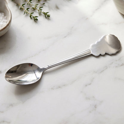 Versatile stainless steel carved handle dinner spoon for home and restaurant dining.
