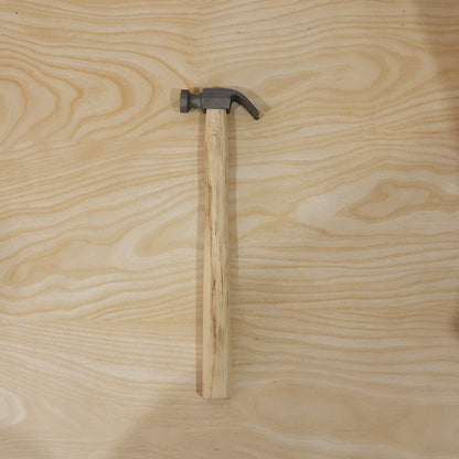 Person using claw hammer to drive a nail in carpentry