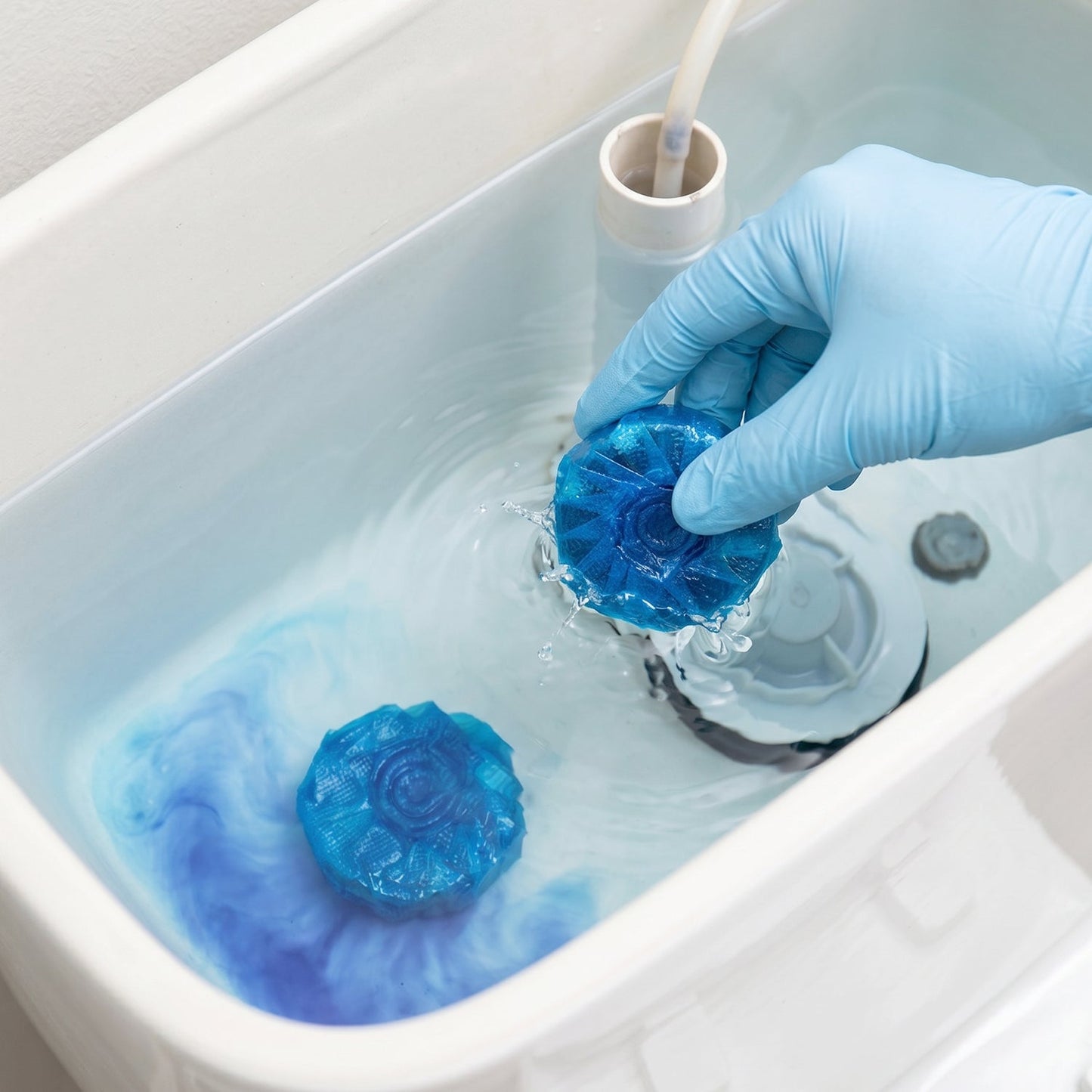 Long-lasting toilet cleaner block in use in the cistern